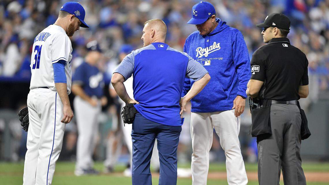 Royals manager Ned Yost looked on as head trainer Nick Kenney checked on starter Ian Kennedy in the third inning of Tuesday's baseball game against the Brewers on April 24, 2018, at Kauffman Stadium. Kennedy finished the third inning before leaving the game.