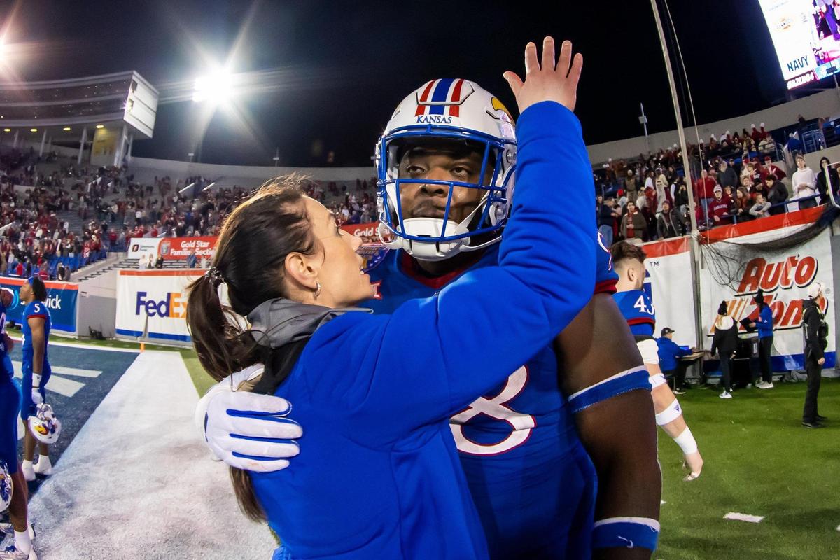 Kansas defensive lineman Caleb Sampson embraces a staff member after his team’s triple overtime loss in the Liberty Bowl to the Arkansas Razorbacks on Wednesday, December 28, 2022, in Memphis, Tenn.