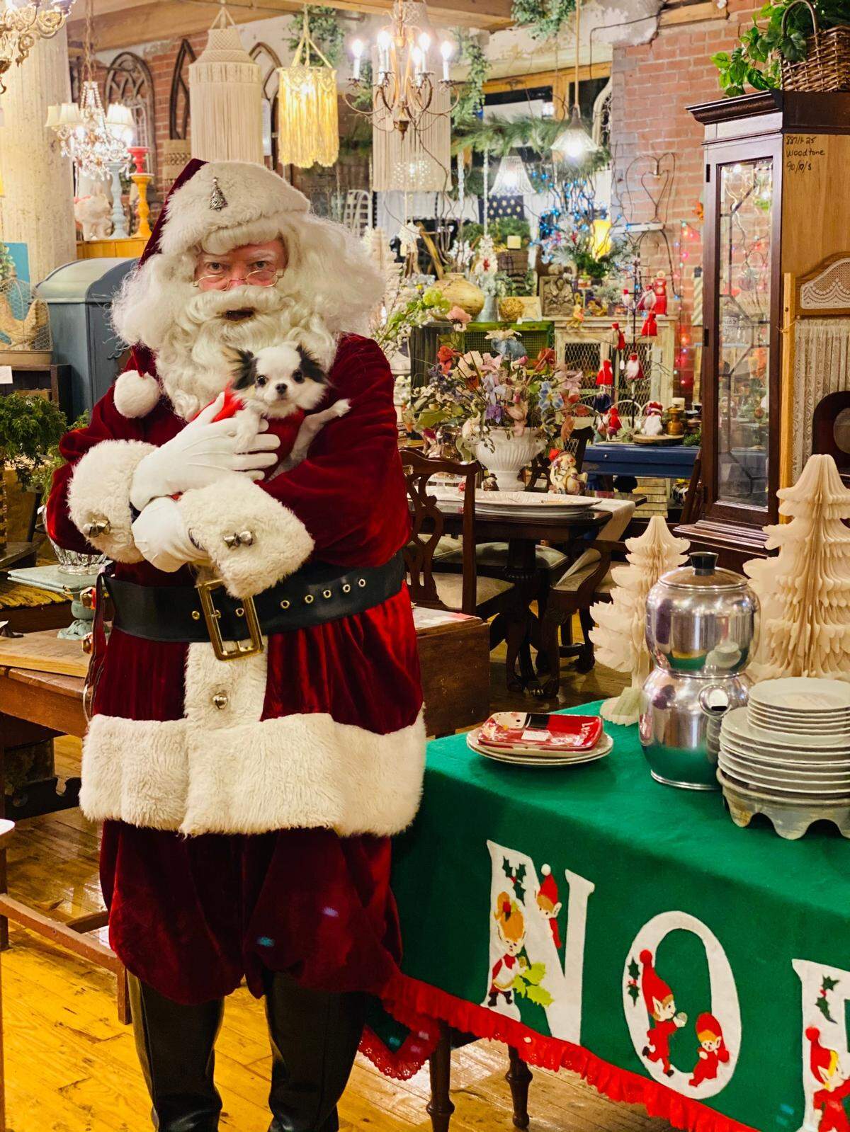 Santa and Tucker, the store’s mascot, pose in Serendipity in the West Bottoms.