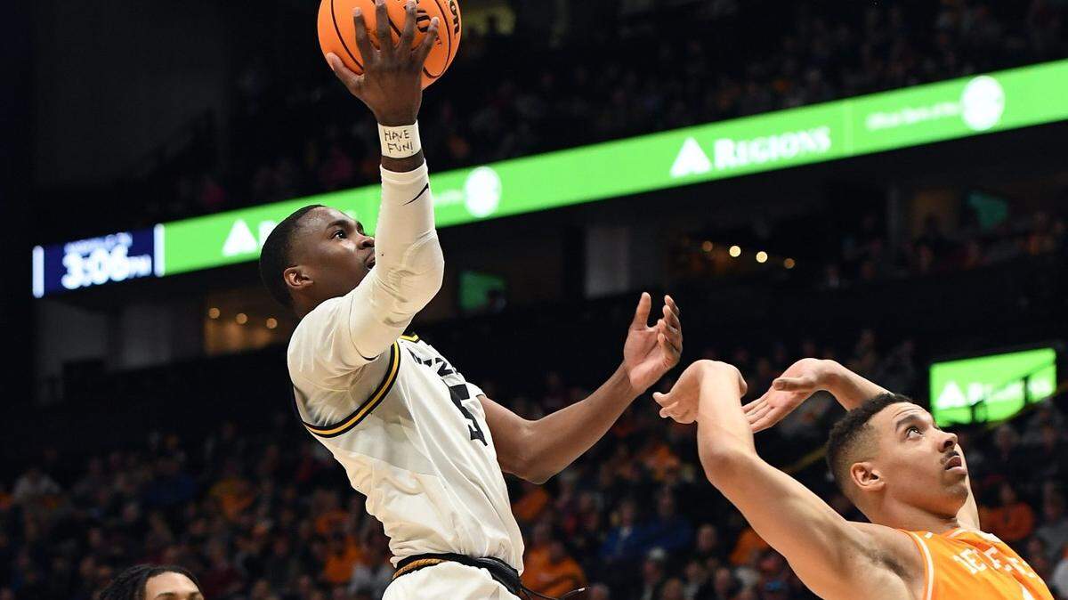 Missouri Tigers guard D’Moi Hodge scores over Tennessee Volunteers guard Tyreke Key during Friday’s SEC Tournament quarterfinal game at Bridgestone Arena in Nashville, Tenn.