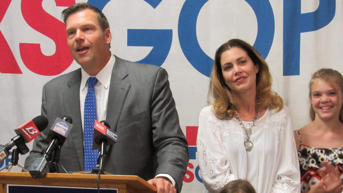 Kansas Secretary of State Kris Kobach, the GOP nominee for governor, delivers a speech at Kansas Republican Party headquarters alongside his wife, Heather Kobach, and their daughters.