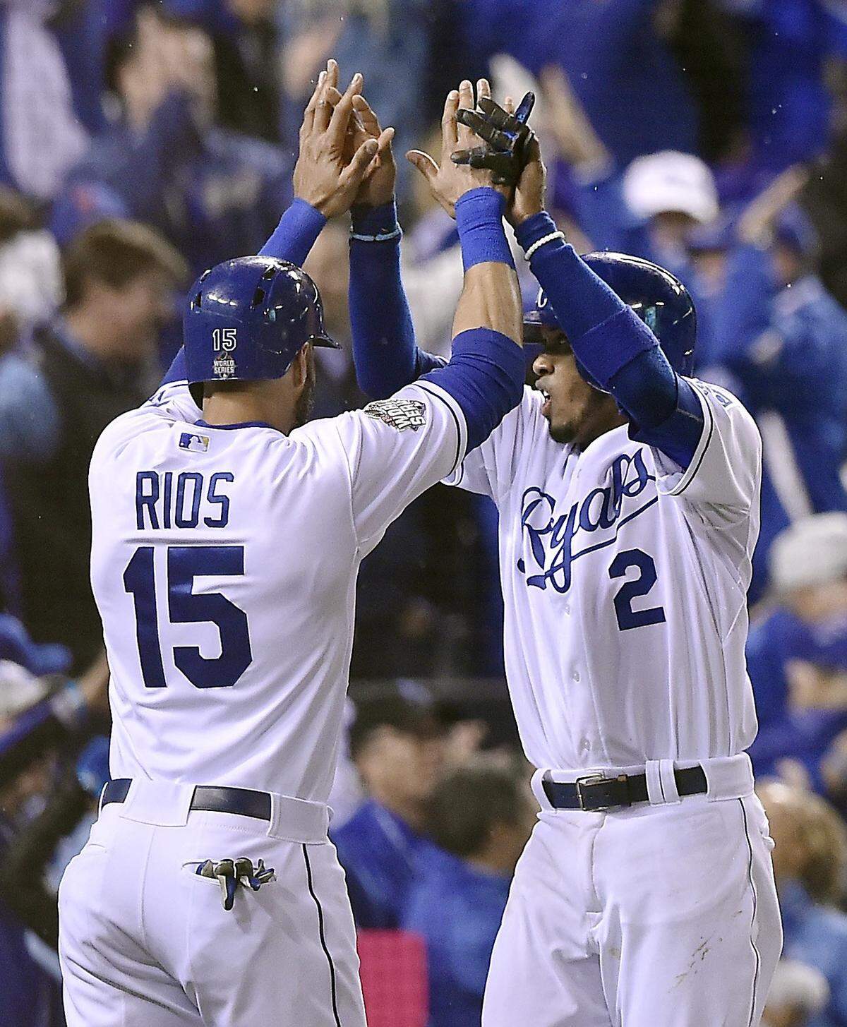Kansas City Royals right fielder Alex Rios and shortstop Alcides Escobar celebrate after they were both driven in to score on a hit by first baseman Eric Hosmer in the fifth inning during Game 2 of the World Series on Wednesday, October 28, 2015 at Kauffman Stadium in Kansas City, Mo.