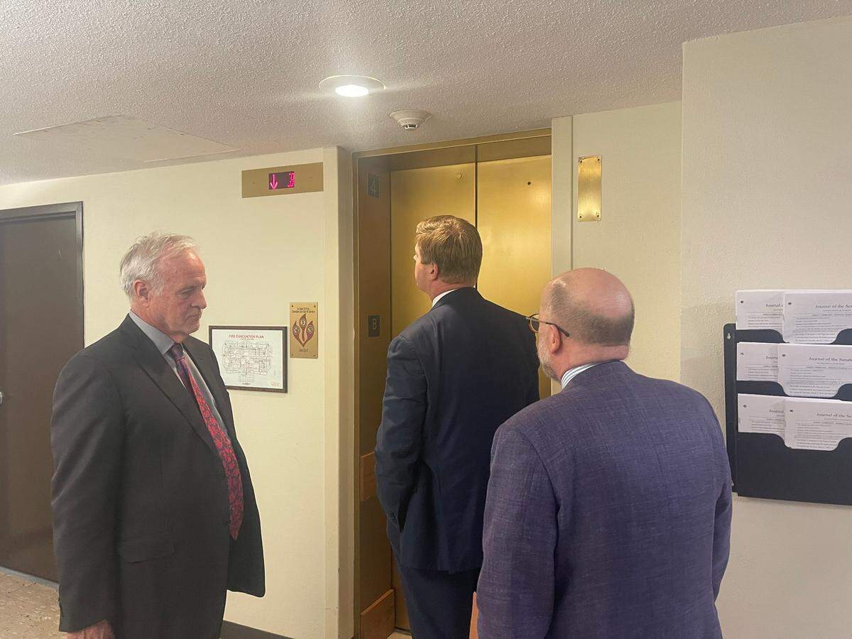 Missouri House Speaker Dean Plocher, a St. Louis area Republican, stands with his attorneys after leaving a House Ethics Committee hearing. He refused to answer questions from reporters.
