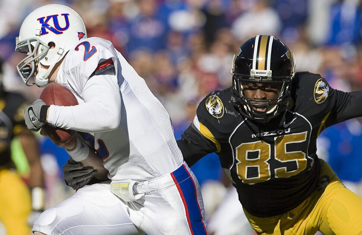Missouri Tigers defensive end Aldon Smith, right, closed in on Kansas Jayhawks quarterback Jordan Webb during a football game at Arrowhead Stadium in Kansas City on Nov 27, 2010.