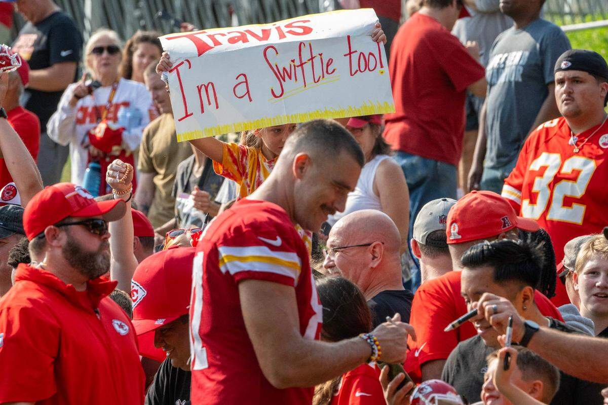 A young fan holds a sign out for Kansas City Chiefs tight end Travis Kelce (87) during the last day of Chiefs training camp on Thursday, Aug. 17, 2023, in St. Joseph, Missouri.