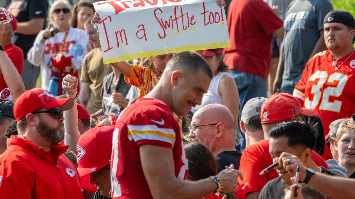 A young fan holds a sign out for Kansas City Chiefs tight end Travis Kelce (87) during the last day of Chiefs training camp on Thursday, Aug. 17, 2023, in St. Joseph, Missouri.