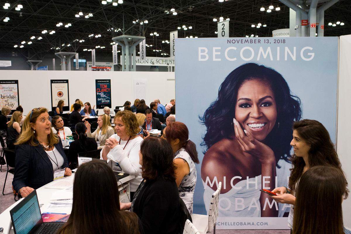A poster for former first lady Michelle Obama’s memoir, Becoming, is displayed in the Penguin Random House exhibit, Thursday, May 31, 2018 at Book Expo in New York. The book will be available in November.