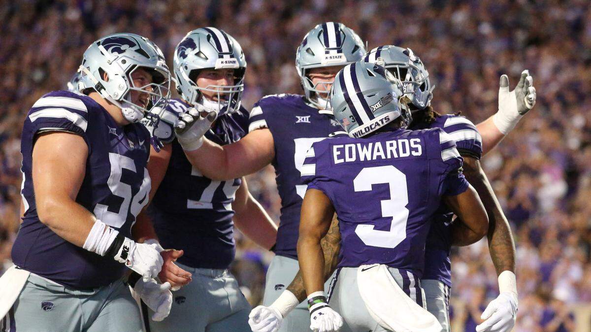 Kansas State Wildcats running back Dylan Edwards (3) is congratulated by teammates after scoring a touchdown in the third quarter against the Tennessee-Martin Skyhawks at Bill Snyder Family Football Stadium on Aug. 31, 2024.