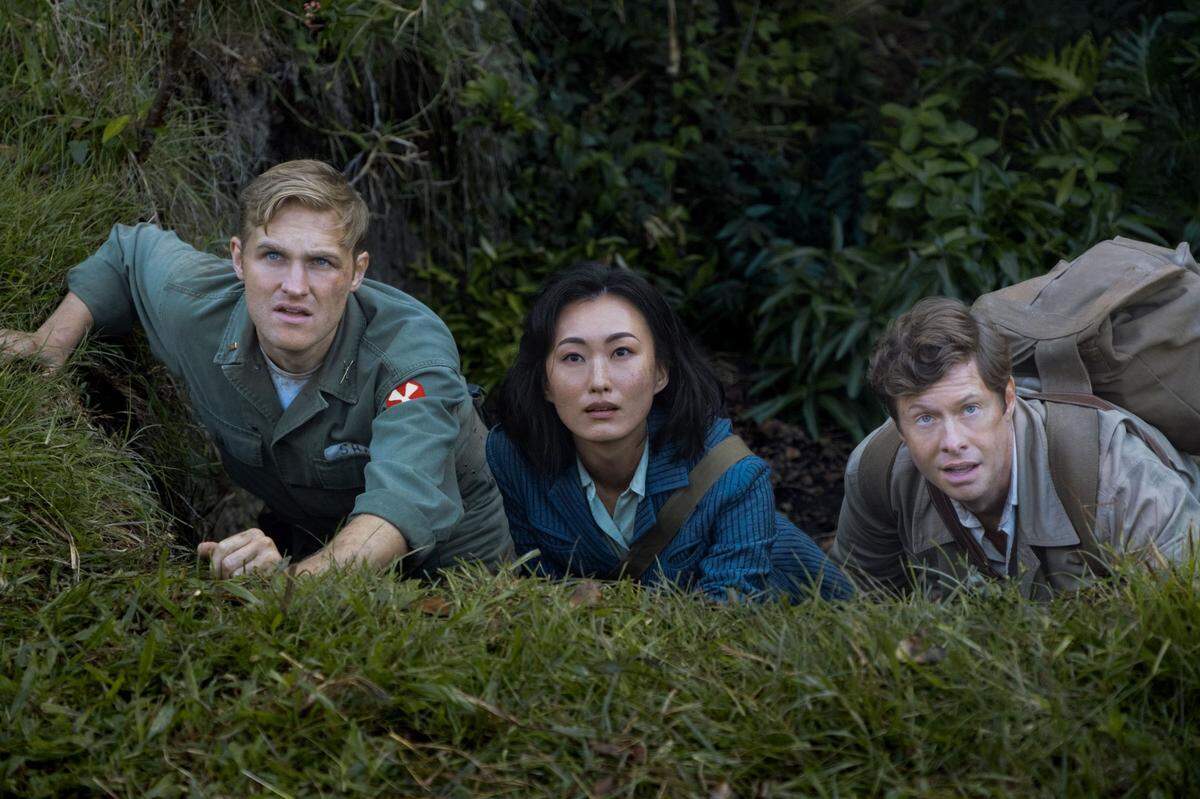 In 1959, Army Lt. Lee Shaw (Wyatt Russell, left, Kurt Russell’s son in real life) must protect researchers Keiko Maira (Mari Yamamoto) and Bill Randa (Anders Holm).