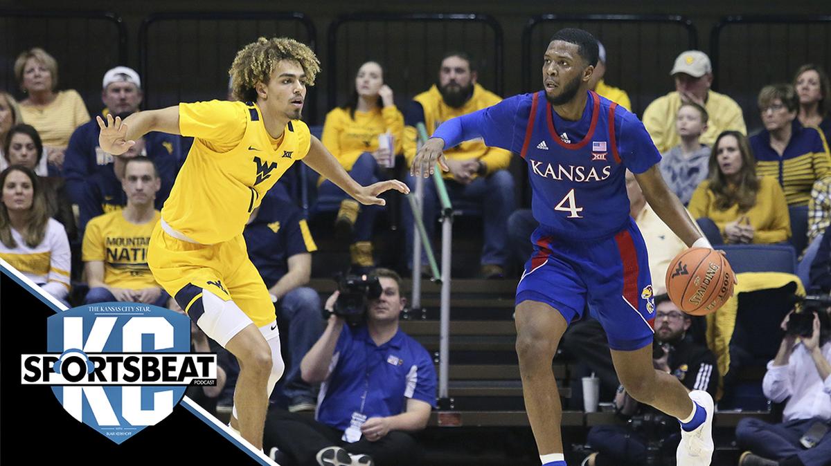 Kansas guard Isaiah Moss (4) is defended by West Virginia forward Emmitt Matthews Jr. (11) during the second half of an NCAA college basketball game Wednesday, Feb. 12, 2020, in Morgantown, W.Va. (AP Photo/Kathleen Batten)