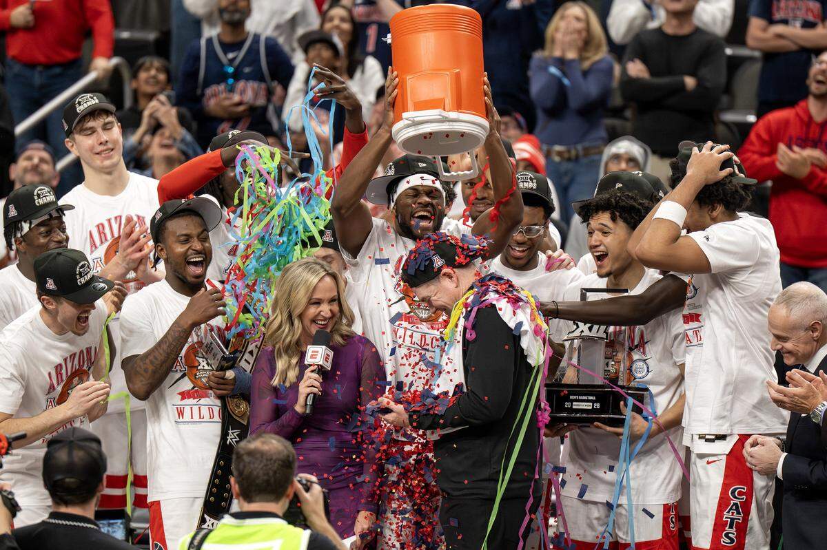 Arizona players dump confetti on head coach Tommy Lloyd after defeating the Houston Cougars 79-74 in the Big 12 Men's Basketball Tournament Championship game at T-Mobile Center on Saturday, March 14, 2026, in Kansas City.