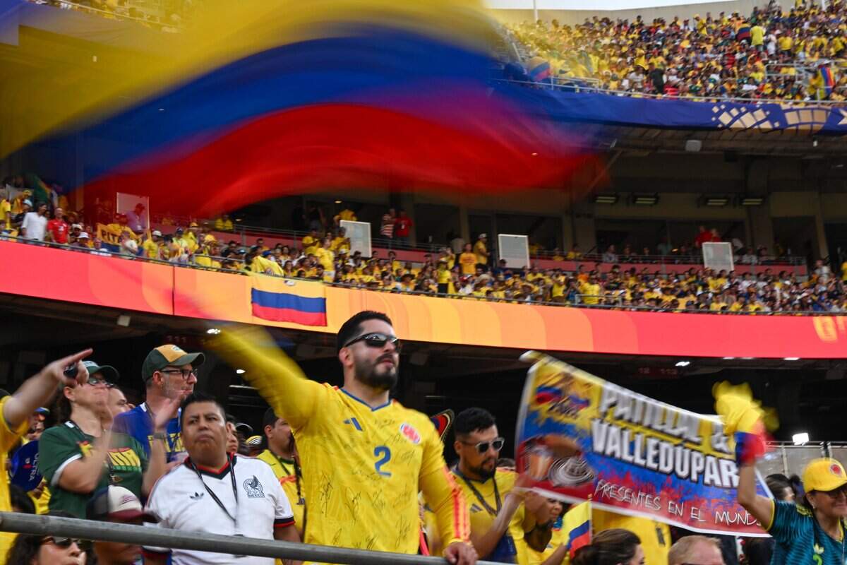 Colombian flags wave in the stands as teams are introduced at the Colombia vs. Ghana 2026 World Cup round of 32 football match at Kansas City (Arrowhead) Stadium in Kansas City on Friday, July 3, 2026.