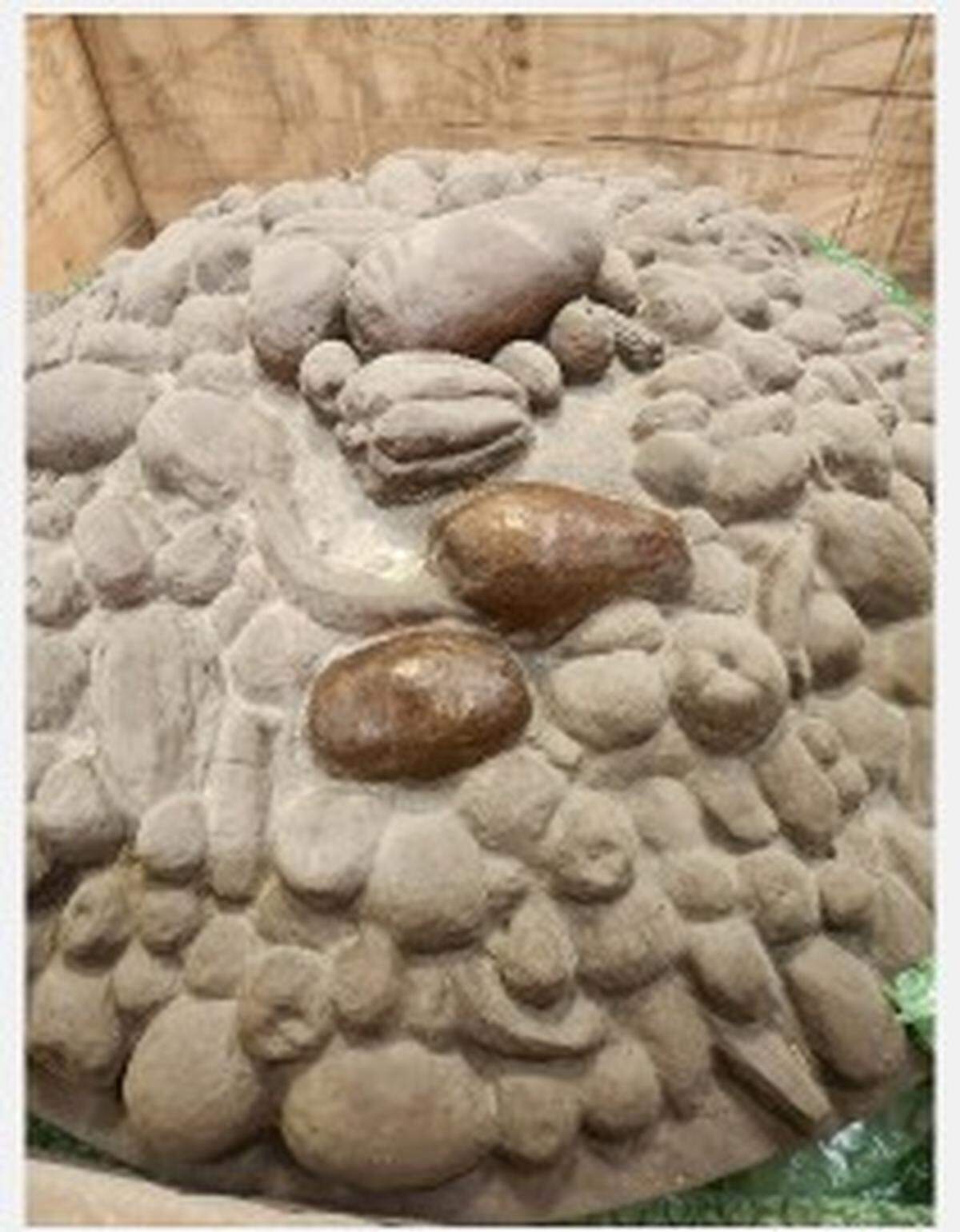 Dust removed from bowl of fruit, part of Las Tarascas sculpture, shows its bronze color. The sculpture, a gift in 2013 from Morelia, Mexico, has beenin storage for 12 years.