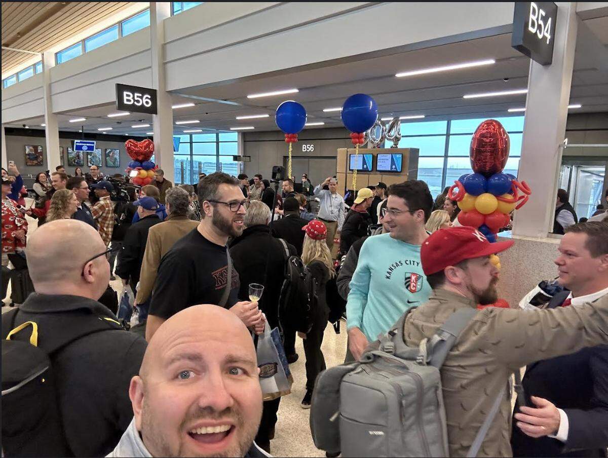 In a provided photo, James Larson, of Overland Park, takes a selfie with other passengers getting off the first flight to arrive at the new KCI terminal on Tuesday, Feb. 28, 2023.