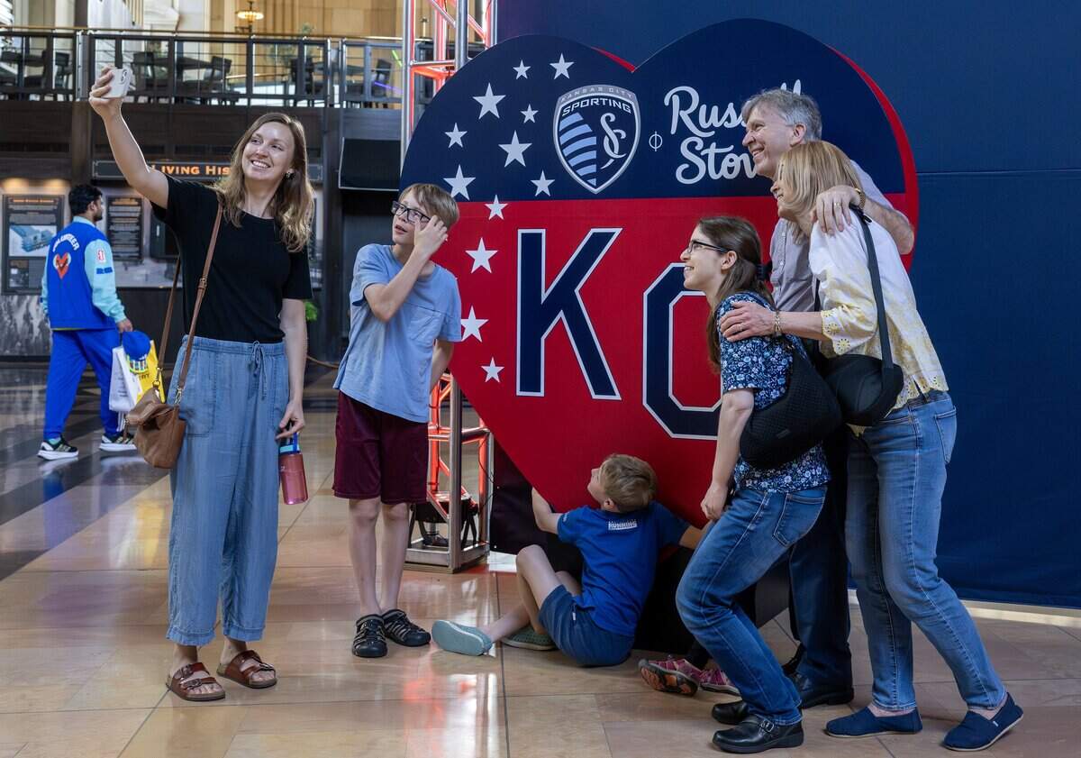 Visitors take photos next to a Russell Stover and Sporting Kansas City-themed heart display inside Union Station on Tuesday, June 9, 2026, in Kansas City.