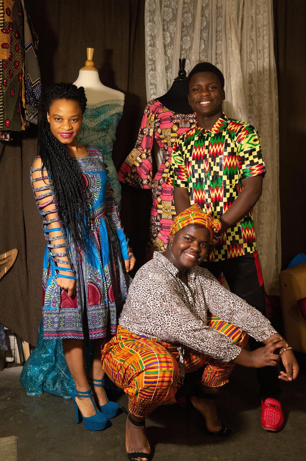 From front to back and left to right, Maria Amisi, 17, Liliane Lemani’s daughter, Christine Amisi, 24, Lemani’s sister and Albert Amisi, 16, Lemani’s nephew, model clothes made with traditional African garments by Lemani.