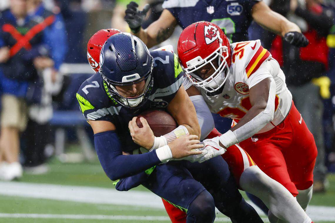 Kansas City Chiefs cornerback Christian Roland-Wallace (30) tackles Seattle Seahawks quarterback Drew Lock (2) during the second quarter at Lumen Field on Aug. 15, 2025.