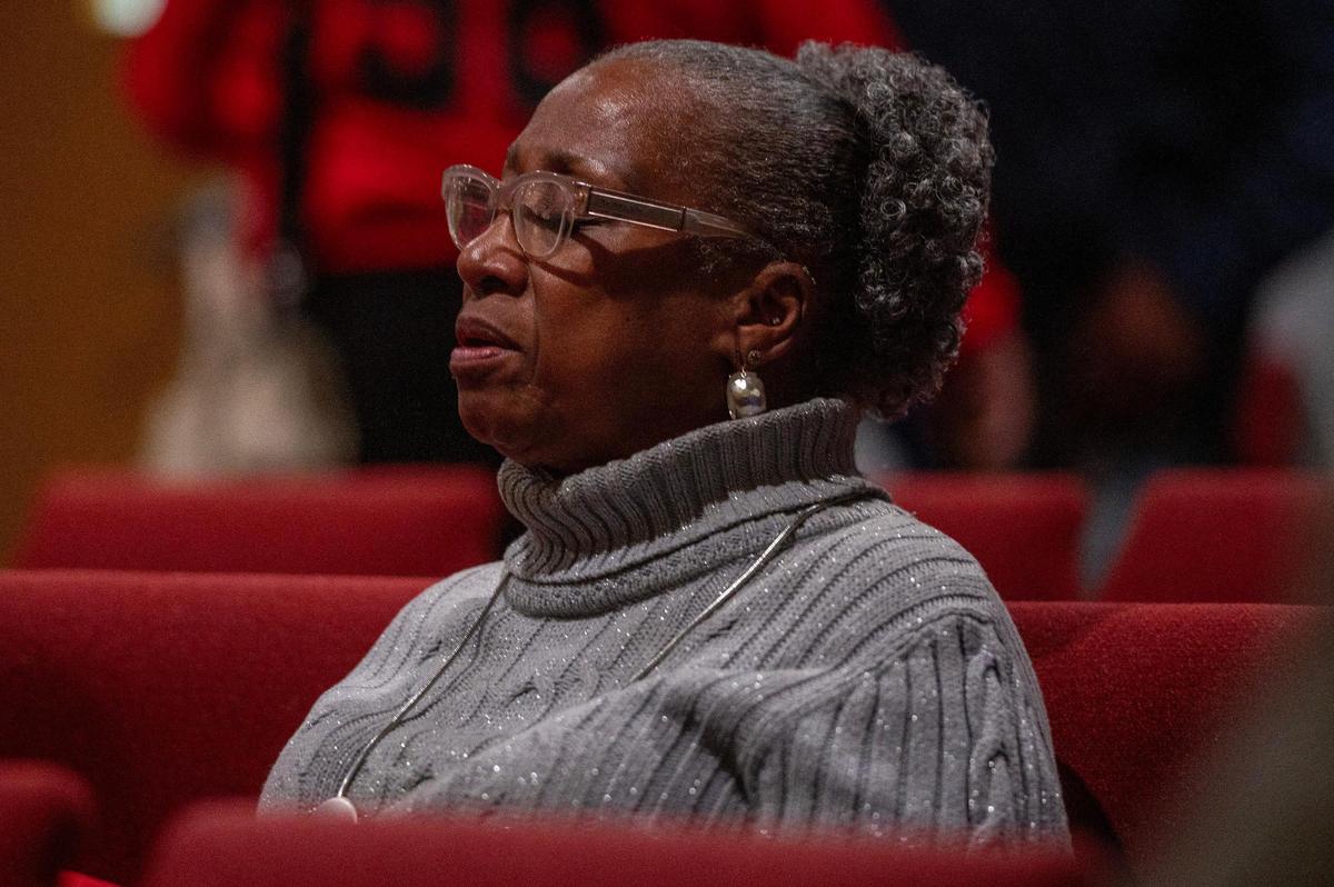Barbara Tillman, silently sings during a church service at The Gathering Church on Thursday, Dec. 21, 2023, in Independence, Missouri. The gathering aimed to honor the lives of homicide victims in Kansas City for 2023, as attendees united to read the names of these individuals, reflect on their legacies and offer support to those grieving the loss of their loved ones.