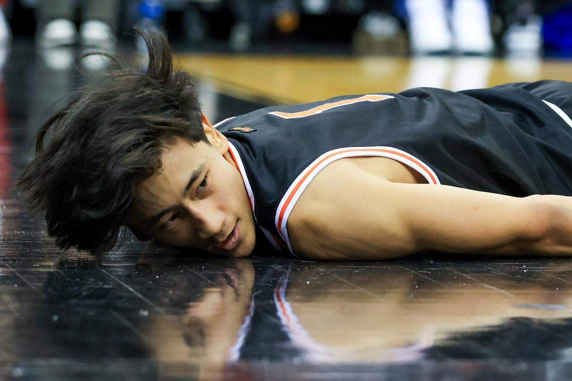 Princeton Tigers guard Xaivian Lee (1) falls to the floor during the second half against Rutgers Scarlet Knights at Prudential Center on Dec. 21, 2024.