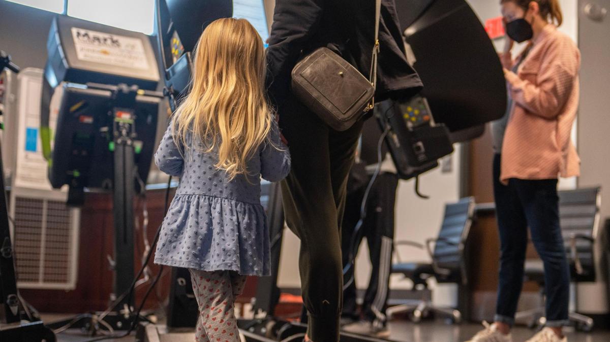 Three-year-old Emerson Thompson, left, waits as her mother Laura Thompson casts her vote in the midterm elections at Fairway City Hall on Tuesday, Nov. 8, 2022.