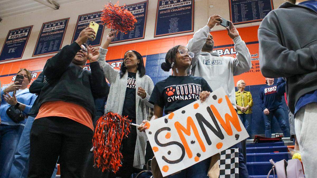 Delesa Carter 43, center, is seen with her family cheering on her daughter Darcel Carter, a freshman from Shawnee Mission Northwest, in the Kansas State High School Athletics Association Girls Gymnastics Championship on Saturday, Oct. 25, 2025 in Olathe.