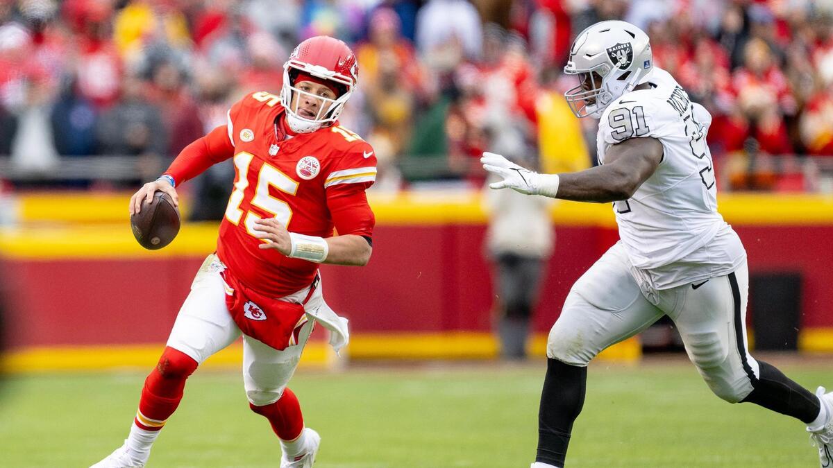 Kansas City Chiefs quarterback Patrick Mahomes (15) tries to run by Las Vegas Raiders defensive tackle Bilal Nichols (91) during an NFL football game on Monday, Dec. 25, 2023, at Arrowhead Stadium at GEHA Field in Kansas City.