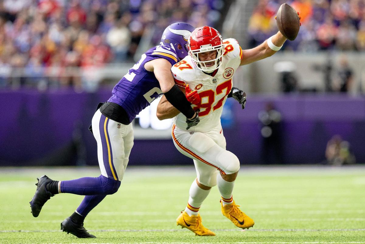 Kansas City Chiefs tight end Travis Kelce (87) tries to escape a tackle attempt by Minnesota Vikings safety Harrison Smith (22) during an NFL football game on Sunday, Oct. 8, 2023, at U.S. Bank Stadium in Minneapolis, Minn.