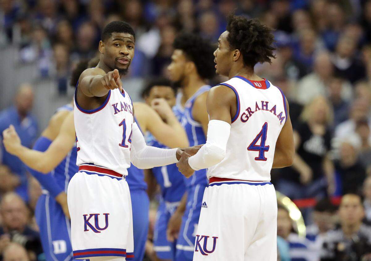 Malik Newman #14 and Devonte' Graham #4 of the Kansas Jayhawks discuss the play against the Duke Blue Devils during the first half in the 2018 NCAA Men's Basketball Tournament Midwest Regional at CenturyLink Center on March 25, 2018 in Omaha, Nebraska.