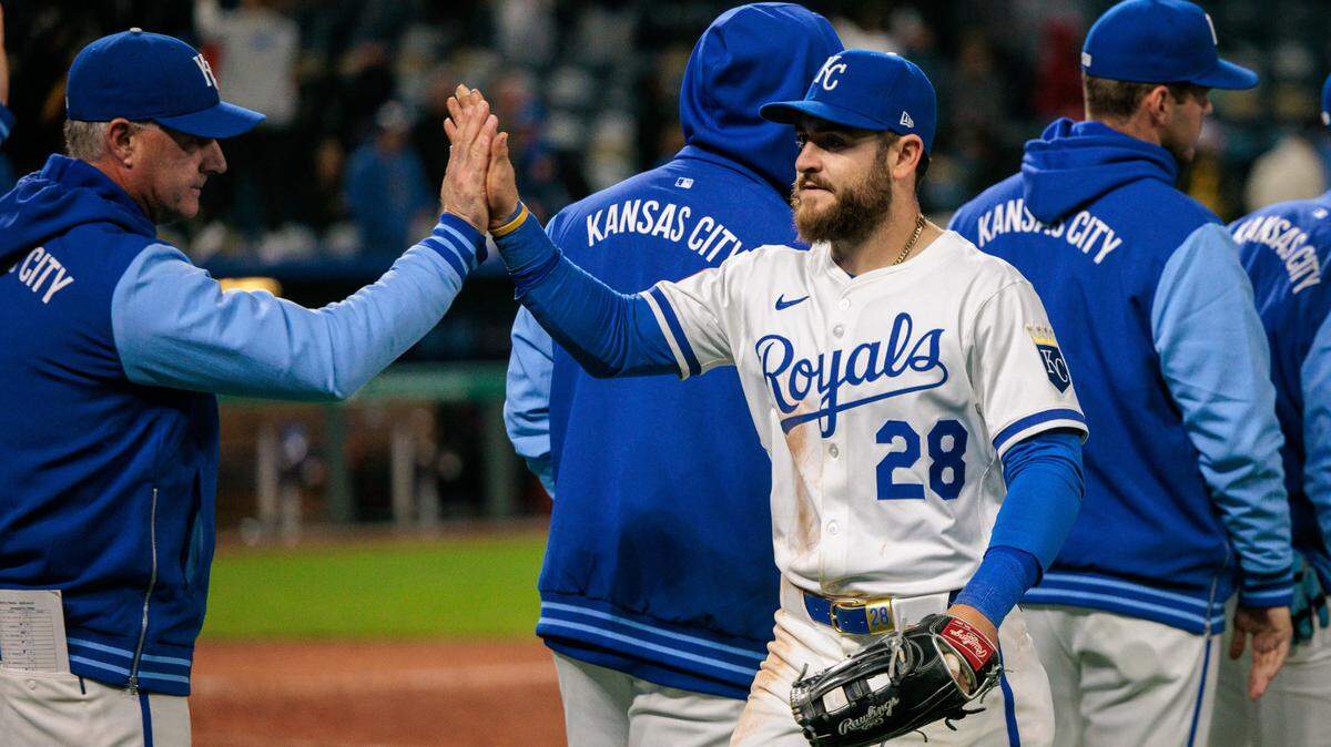 Kansas City Royals outfielder Kyle Isbel (28) slaps hands with the team after the game against the Minnesota Twins at Kauffman Stadium on Monday.
