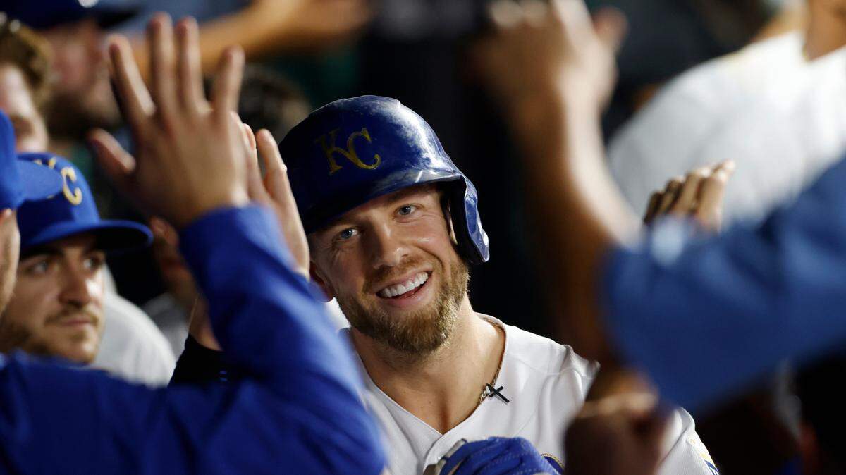 Kansas City Royals’ Hunter Dozier reacts in the dugout after hitting a home run during the fifth inning of a baseball game against the Minnesota Twins in Kansas City, Mo., Friday, Oct. 1, 2021. (AP Photo/Colin E. Braley)