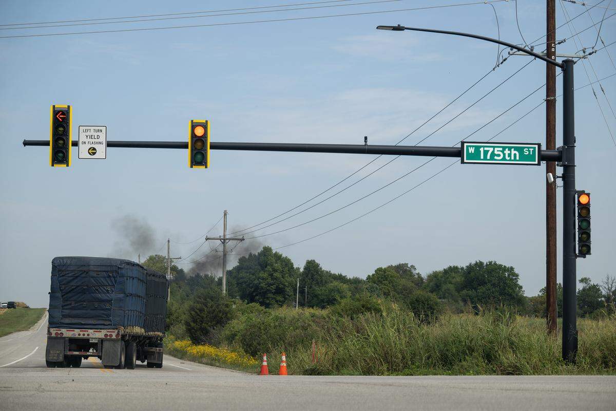 A semi truck billows black smoke as it travels norther on Lone Elm Road and 175th Street in Olathe on Tuesday, Sept. 16, 2025. Residents of the Nottington Creek Homeowners Association are concerned about a proposed 146-acre cold storage facility from Lineage Logistics near West 175th Street and Lone Elm Road. They live a half-mile from the proposed site and worry about the potential impacts on traffic, safety, and air quality.