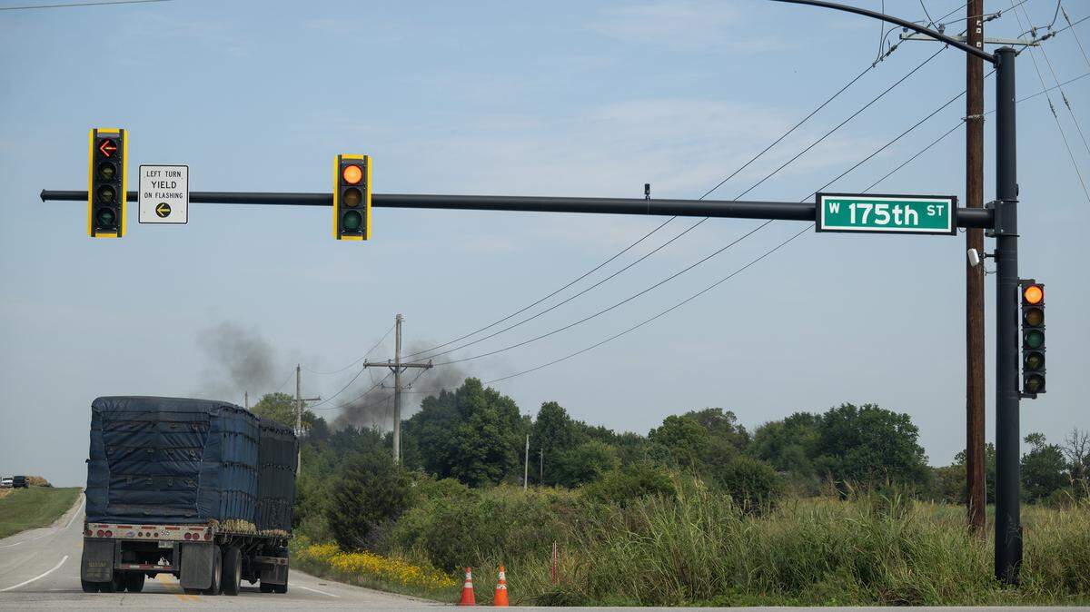 A semi truck billows black smoke as it travels norther on Lone Elm Road and 175th Street in Olathe on Tuesday, Sept. 16, 2025. Residents of the Nottington Creek Homeowners Association are concerned about a proposed 146-acre cold storage facility from Lineage Logistics near West 175th Street and Lone Elm Road. They live a half-mile from the proposed site and worry about the potential impacts on traffic, safety, and air quality.