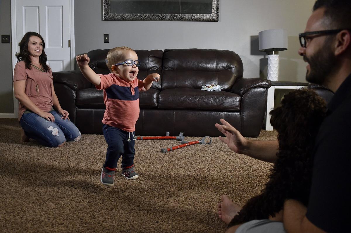 Roman is starting to take steps on his own with his mom, Whitney, and dad, Adam, helping him. “We don’t know what (Roman’s) future holds,” Whitney says. “With spina bifida, it’s always ‘Wait and see.’”