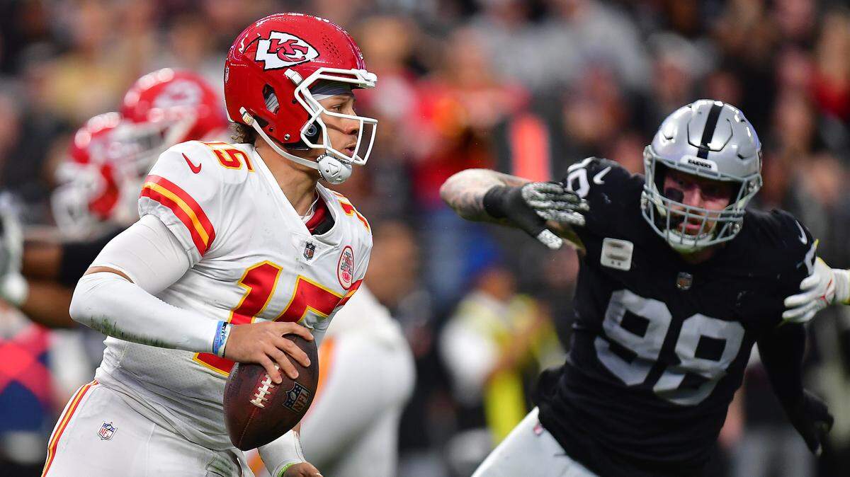 Kansas City Chiefs quarterback Patrick Mahomes (15) holds the ball as Las Vegas Raiders defensive end Clelin Ferrell (99) pursues during the first half at Allegiant Stadium on Jan. 7, 2023.