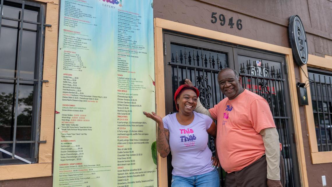 Ashley Frazier and her father, Aaron Frazier, with their extensive menu at This & That Eatery.