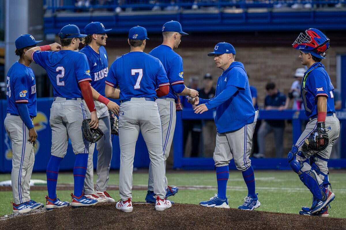Kansas pitching coach Brandon Scott walks to the mound to remove pitcher Mason Cook (43) during the second inning of an NCAA Super Regional baseball game against Oklahoma at Hoglund Ballpark on Sunday, June 7, 2026, in Lawrence.