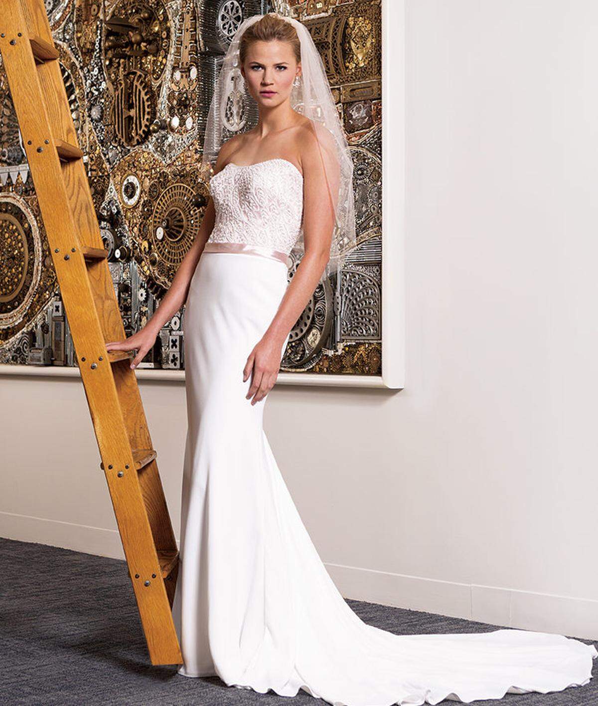 TIMELESS BEAUTY Madison James crepe and charmeuse sheath dress, $1,168, and blush Bel Aire Bridal veil, $69, from Mia's Bridal and Tailoring. Bel Air Bridal tiered earrings, $150 as set, from Wedding Expressions by Geri.