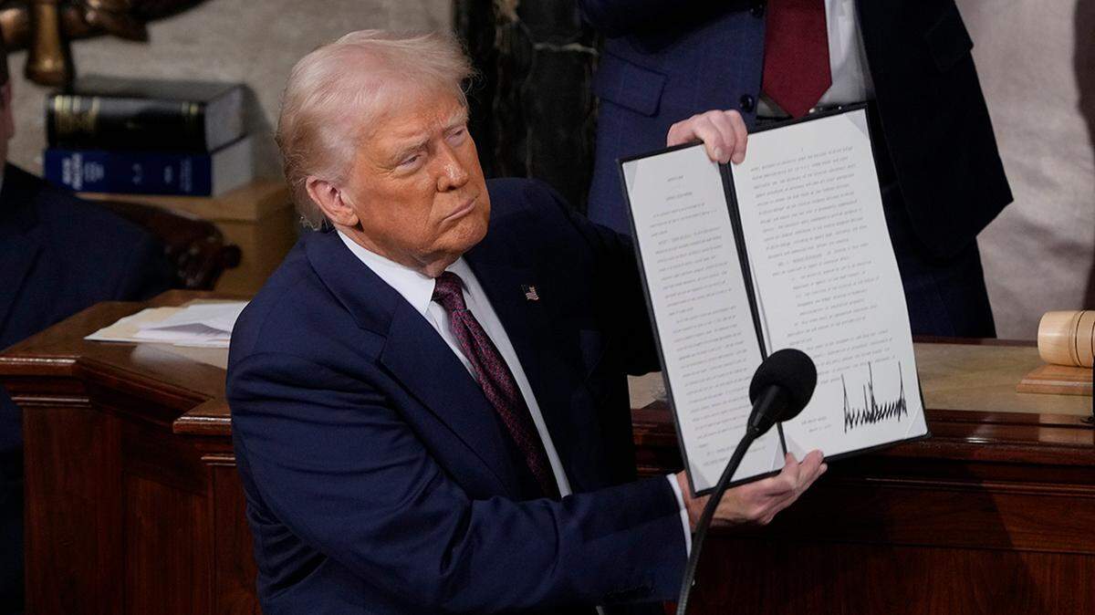 President Donald Trump holds up an executive order that renames a wildlife sanctuary in honor of the late Jocelyn Nungaray, a 12 year-old girl who was allegedly murdered by two undocumented migrants, during an address to a joint session of Congress at the U.S. Capitol in Washington, D.C., on March 4, 2025.