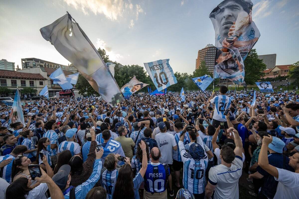 Argentina supporters celebrate during a pregame gathering ahead of Argentina's FIFA World Cup match against Algeria at Mill Creek Park on Monday, June 15, 2026, in Kansas City.