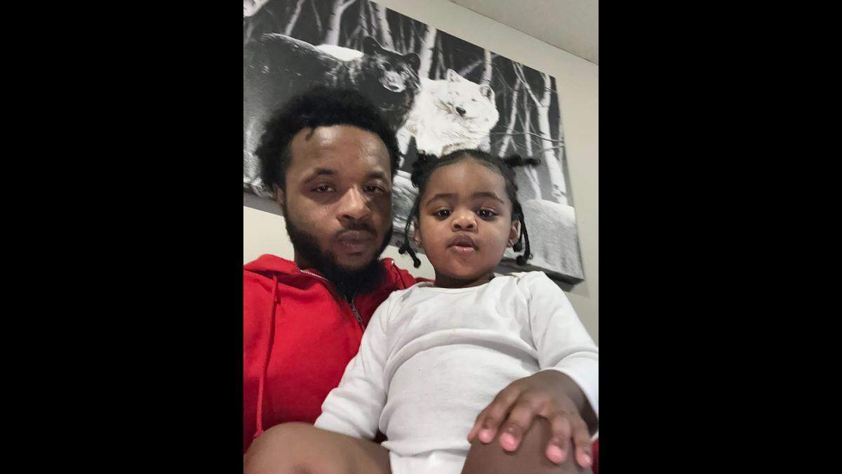 Markese Gleghorn, 21, sits with his 1-year-old daughter. Gleghorn planned to have a large family with his high school sweetheart before he was found shot in January outside a Lenexa McDonald’s and pronounced dead.