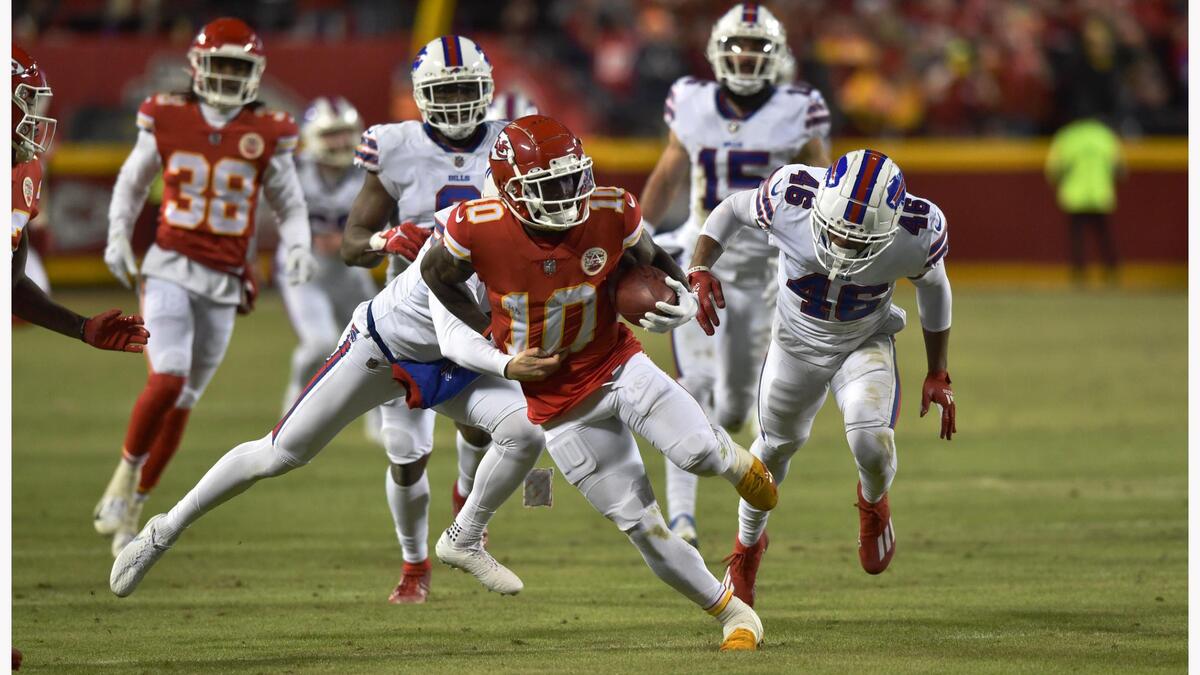 Kansas City Chiefs wide receiver Tyreek Hill jets down the field on a 46-yard punt return eluding Buffalo Bills defenders in the fourth quarter Sunday, January 23, 2022, at Arrowhead Stadium.