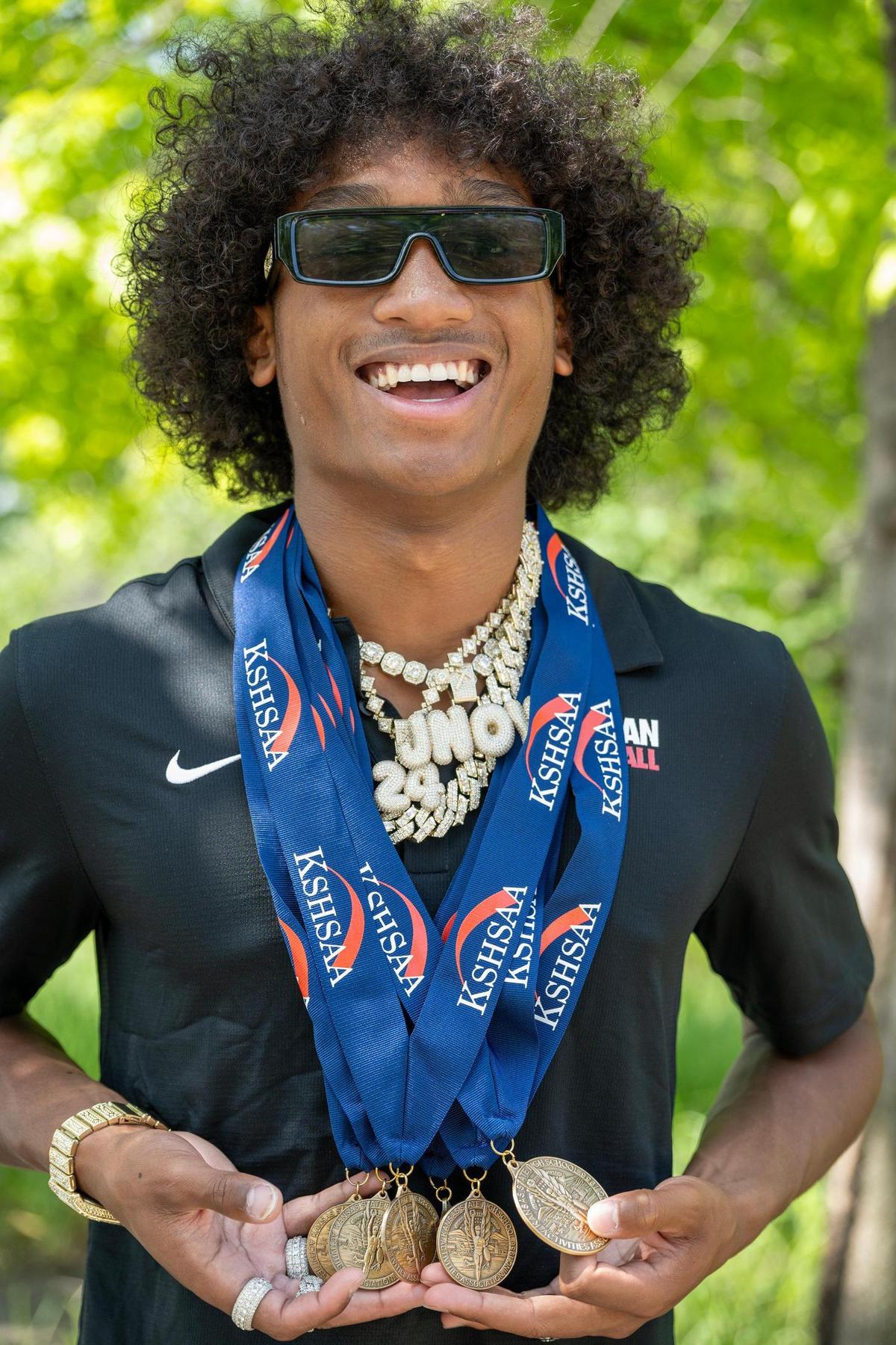 Jaalan Watson, 18, a graduate of Olathe North High School, displays some of the medals he won at Kansas State High School Activities Association’s track meets including the 6A state champion in the triple jump of 47-3.25.