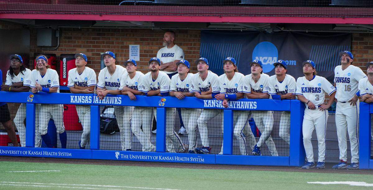 Kansas Jayhawks players watch a fly ball during NCAA baseball regionals against the Arkansas Razorbacks at Hoglund Ballpark in Lawrence, Kansas, on Saturday, May 30, 2026.