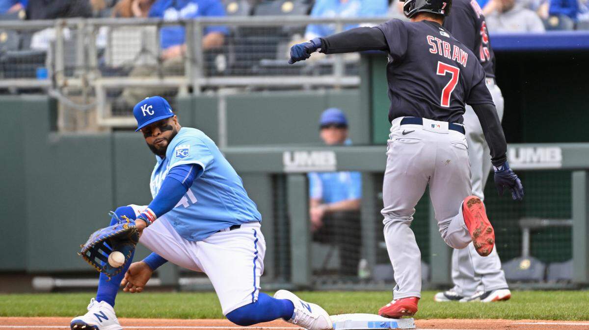 Cleveland Guardians’ Myles Straw beats the throw to Kansas City Royals first baseman Carlos Santana (41) for a single during the first inning of a baseball game, Monday, April 11, 2022 in Kansas City, Mo. (AP Photo/Reed Hoffmann)