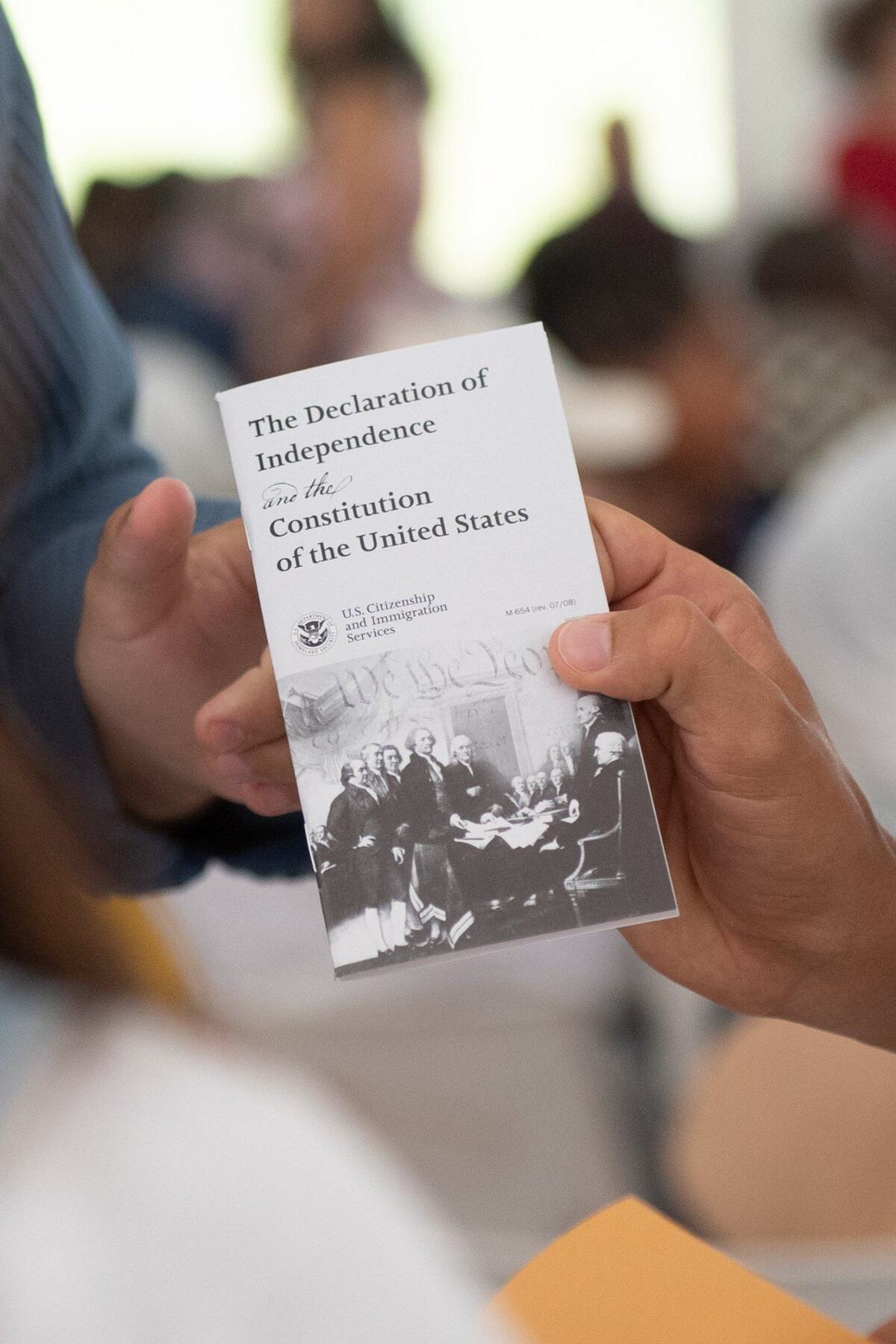 Sporting KC forward Daniel Salloi holds up a pocket copy of the US Declaration of Independence and Constitution.