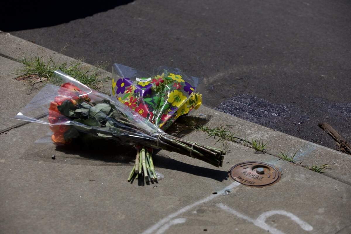 Flowers are laid on the sidewalk at 19th and Vine streets on Saturday, June 20. Police said several people were injured and one man was killed in a shooting in the area the night before.