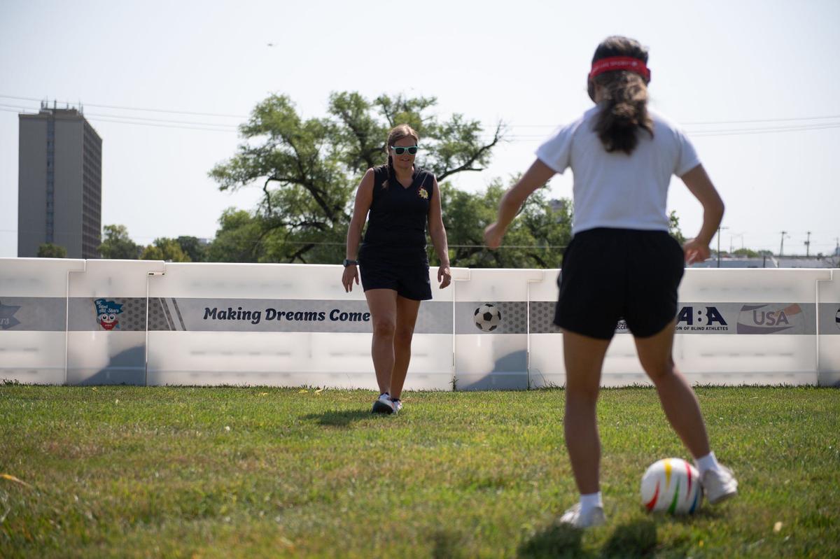 Leah Enright, Kansas State School for the Blind’s blind sports coordinator, teaches blind soccer basics to KC Star intern Kylie Volavongsa at KSSB’s blind soccer field on Thursday, August 1, 2024, in Kansas City, Kansas