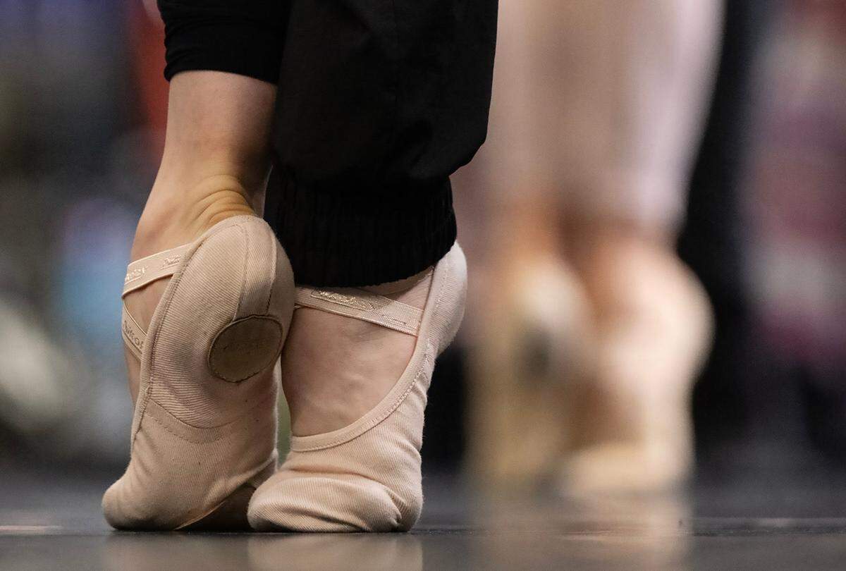 Company Class dancers warm up on stage at the Muriel Kauffman Theatre for the Kansas City Ballet’s final dress rehearsal of “The Nutcracker,” on Wednesday, Dec. 4, 2024, at Kauffman Center. Approximately 224 pairs of pointe shoes will be worn by the company dancers during the duration of “The Nutcracker” performances.