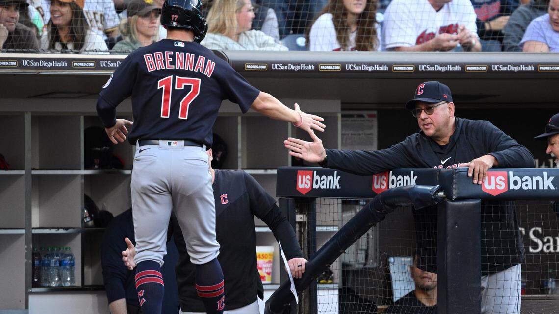 Cleveland Guardians right fielder Will Brennan (17) is greeted at the dugout by manager Terry Francona (right) after scoring a run against the San Diego Padres during the fourth inning at Petco Park.
