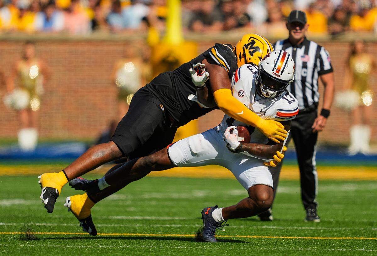 Missouri Tigers defensive tackle Chris McClellan brings down Auburn Tigers tight end Rivaldo Fairweather during Saturday’s game at Faurot Field at Memorial Stadium.